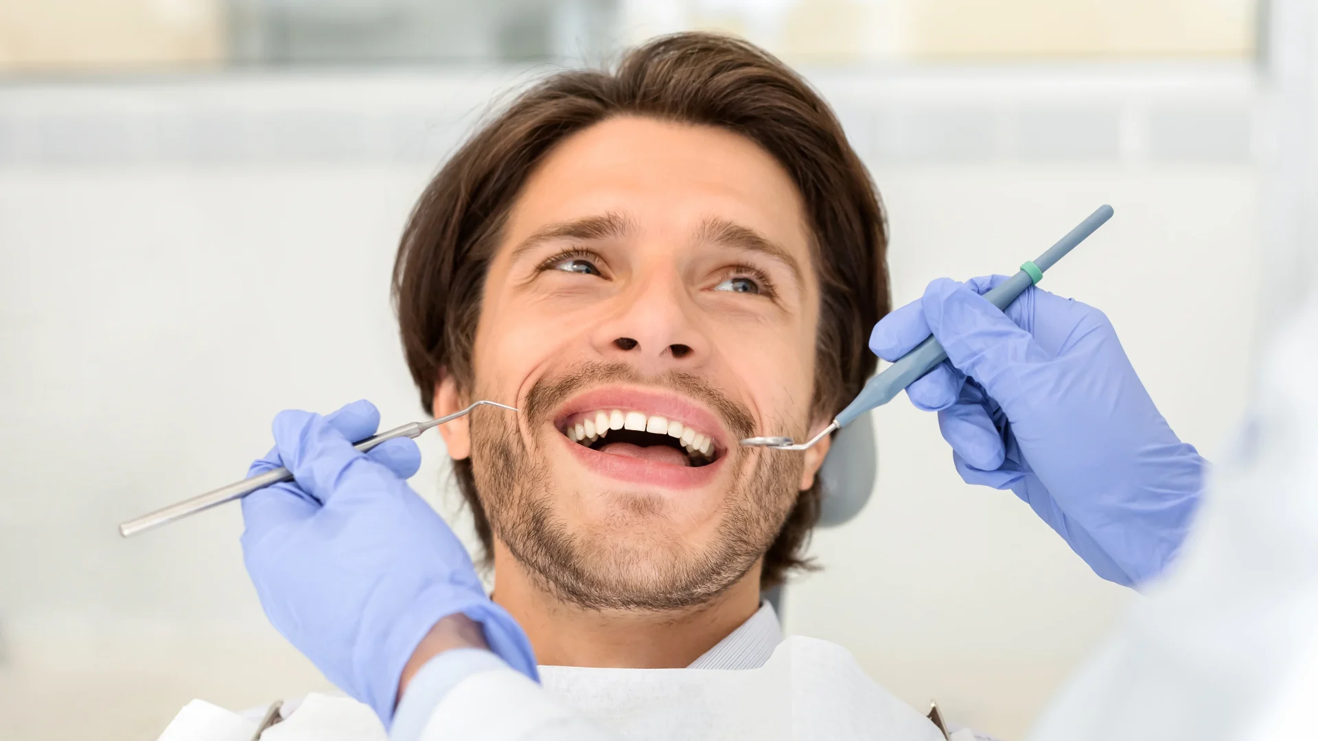 portrait-handsome-smiling-man-attending-dentist