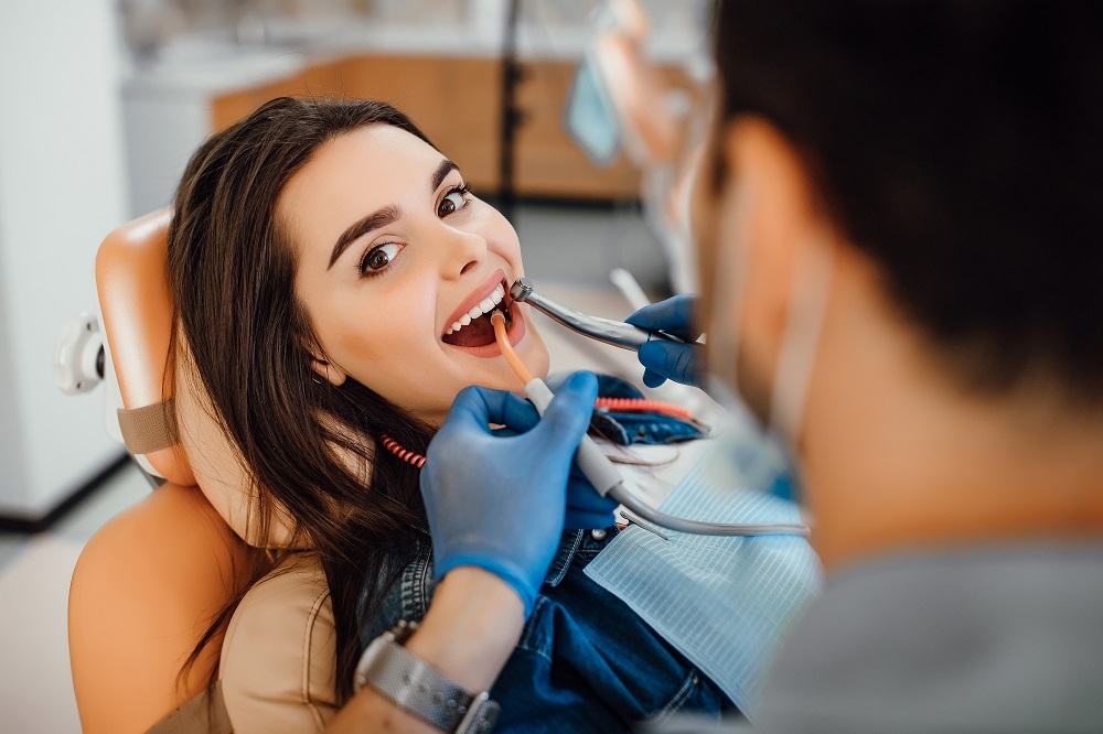 woman taking teeth cleaning treatment